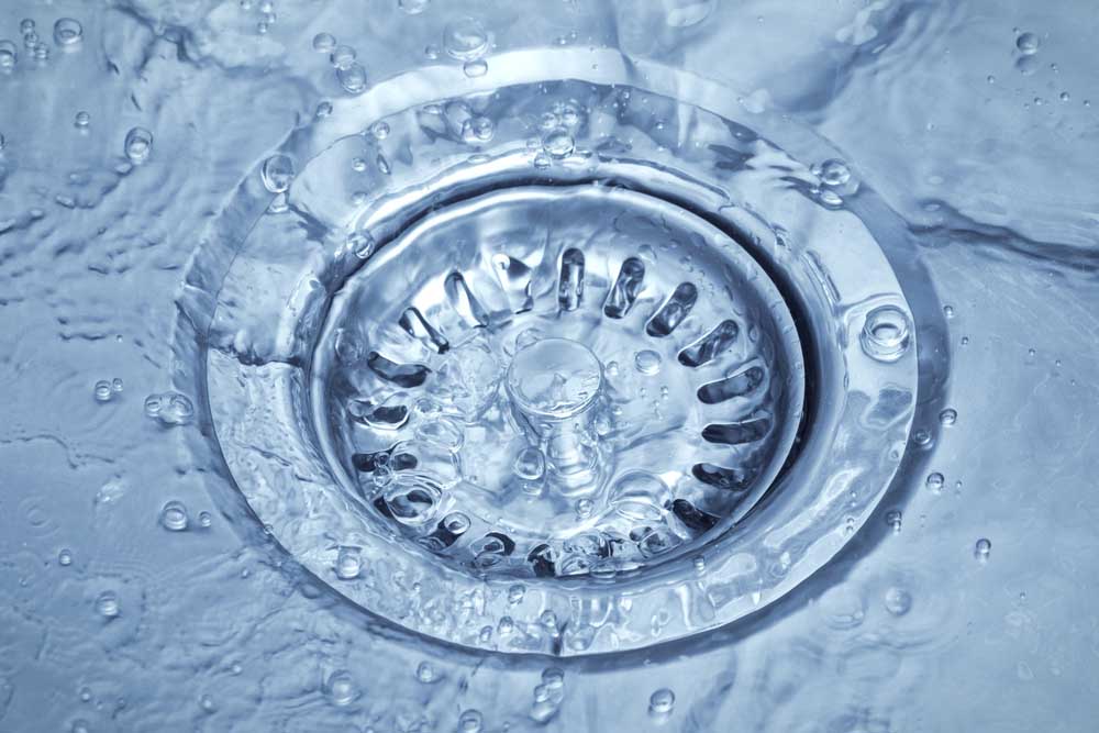 Water flowing down the drain Seattle, WA Water flowing down the drain Seattle, WA