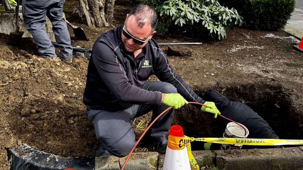 Ready Rooter technician working on sewer repairs Ready Rooter technician working on sewer repairs