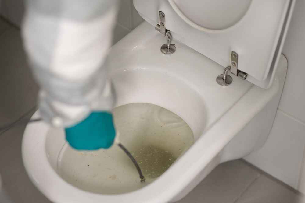 man-cleaning-overflowing-toilet man-cleaning-overflowing-toilet