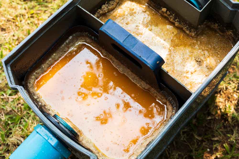 a grease-filled grease trap a grease-filled grease trap