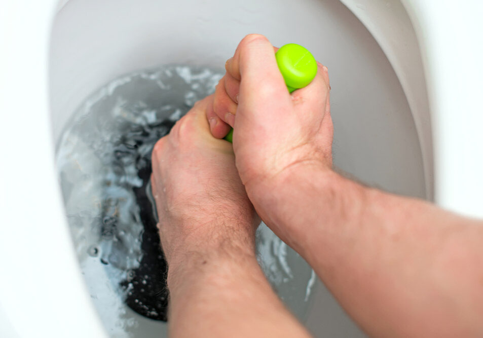 Person using a plunger on a toilet Renton, WA